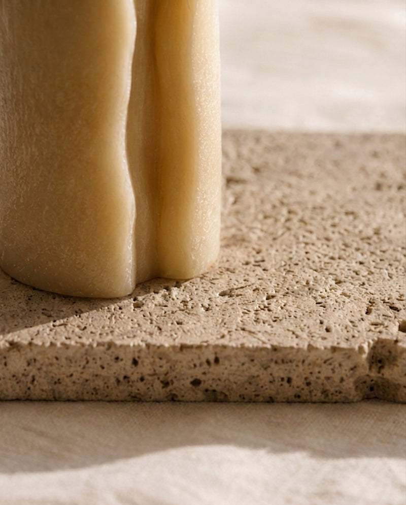 Travertine, for the wax that will drip.