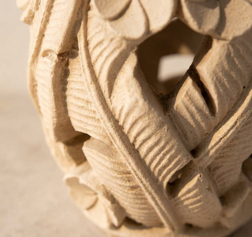 Macro detail of the carved floral lattice on L'Enlacement
