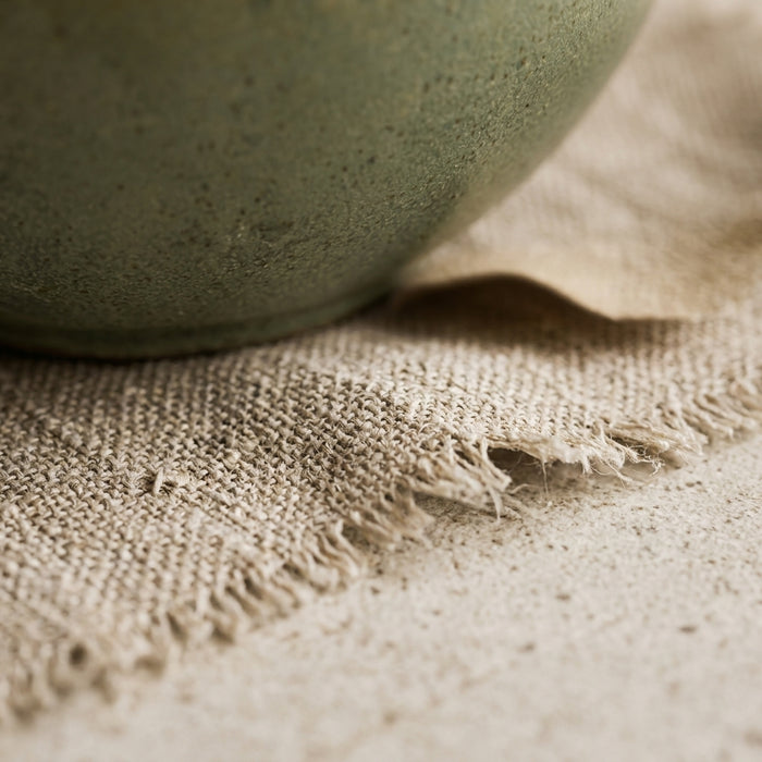 Linen, for a bowl that was never meant to sit on wood alone.